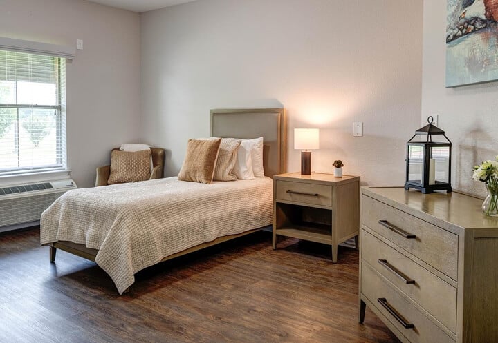 Private Resident Bedroom with Dresser and Natural Light at Assisted Living Facility Private Resident Bedroom with Dresser and Natural Light at Assisted Living Facility