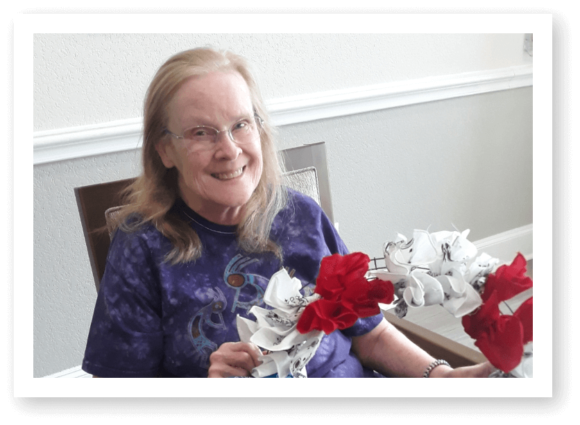 Elderly Woman Creating Floral Craft Project at Assisted Living Facility