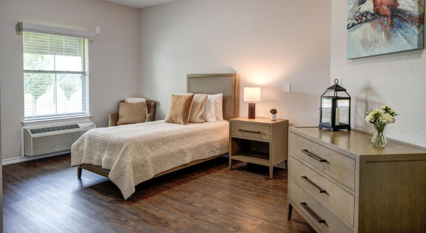 Bright Bedroom with Twin Bed and Wood Flooring at Assisted Living Facility