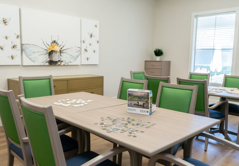 Activity Room with Puzzle Table and Green Chairs at Assisted Living Facility Activity Room with Puzzle Table and Green Chairs at Assisted Living Facility
