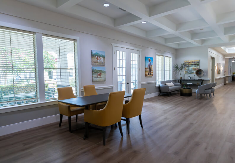Common Room with Yellow Dining Chairs and Coffered Ceiling at Assisted Living Facility Common Room with Yellow Dining Chairs and Coffered Ceiling at Assisted Living Facility