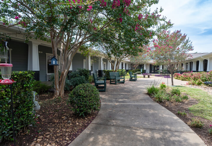 Outdoor Walking Path with Garden Benches at Assisted Living Facility Outdoor Walking Path with Garden Benches at Assisted Living Facility
