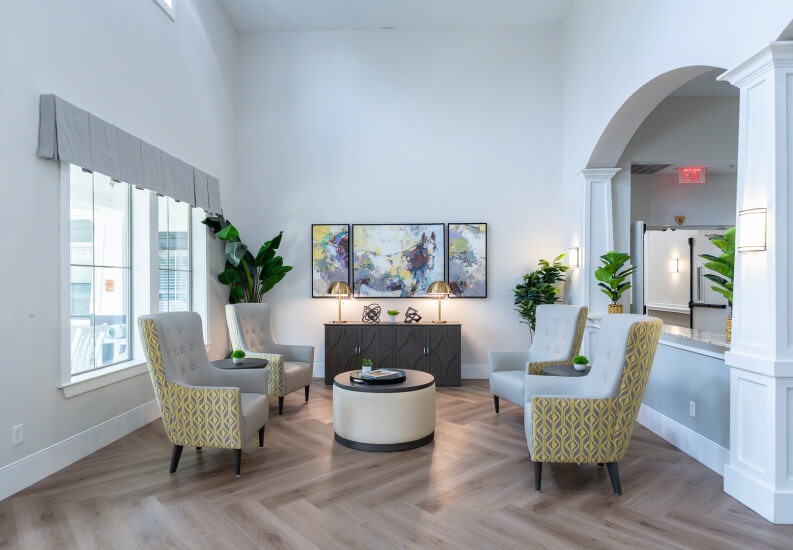 Sitting Area with Yellow Accent Chairs and Triptych Wall Art at Memory Care Facility Sitting Area with Yellow Accent Chairs and Triptych Wall Art at Memory Care Facility