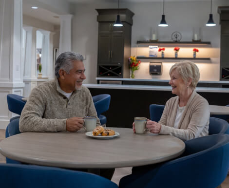 Elderly Couple Having Coffee Together in Dining Area at Assisted Living Facility Elderly Couple Having Coffee Together in Dining Area at Assisted Living Facility