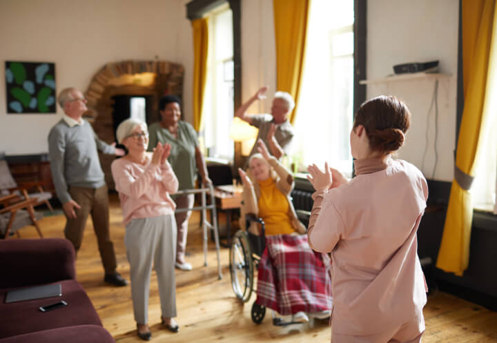 Seniors Joyfully Cheering and Clapping in a Sun-Filled Memory Care Home Seniors Joyfully Cheering and Clapping in a Sun-Filled Memory Care Home