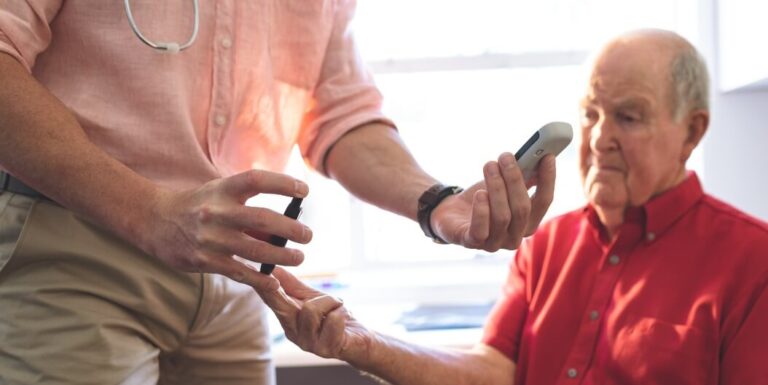Male Nurse Checking Glucose at Memory Care Facility
